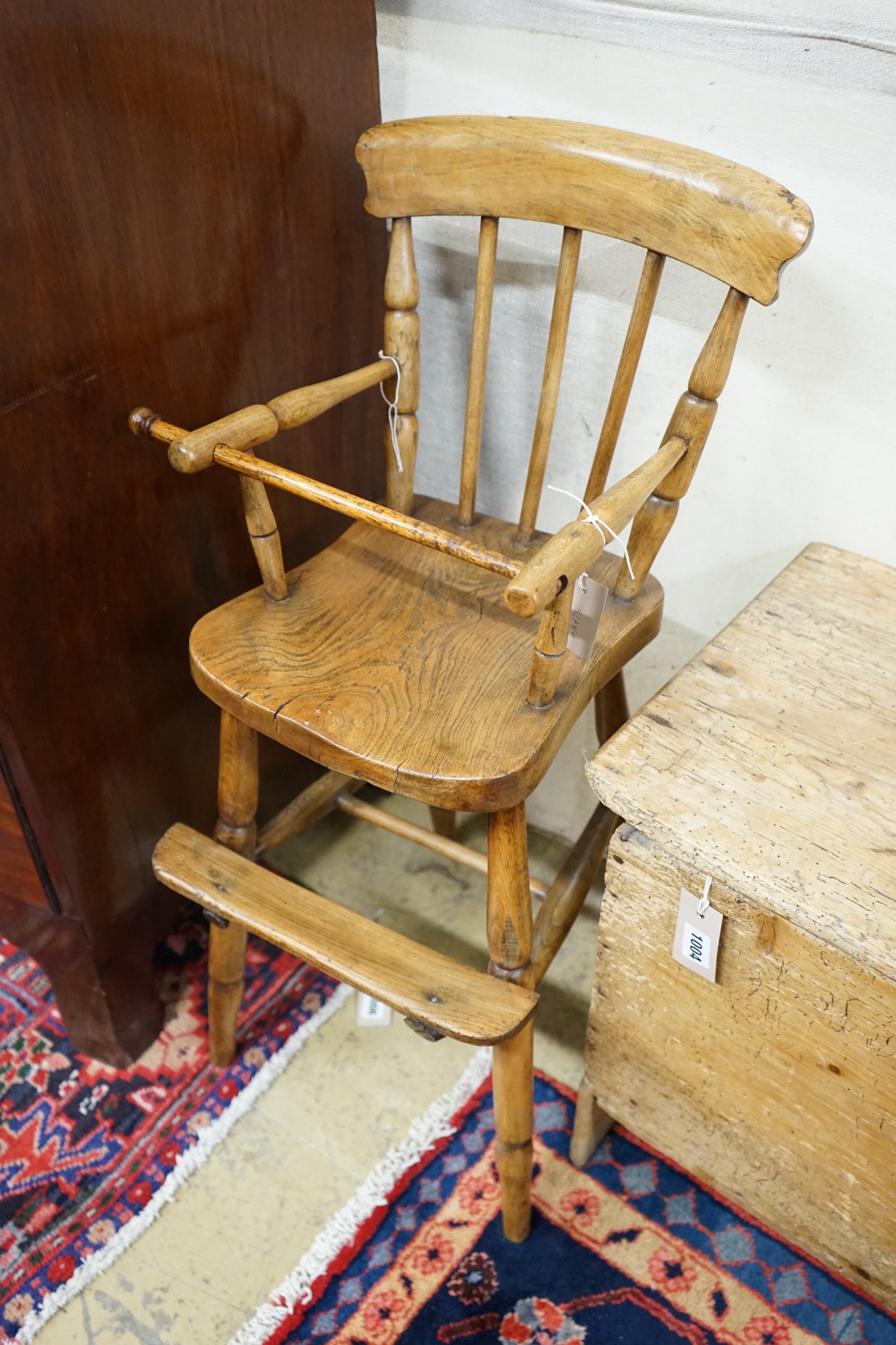 A Victorian elm and beech Windsor comb back child's high chair, height 84cm